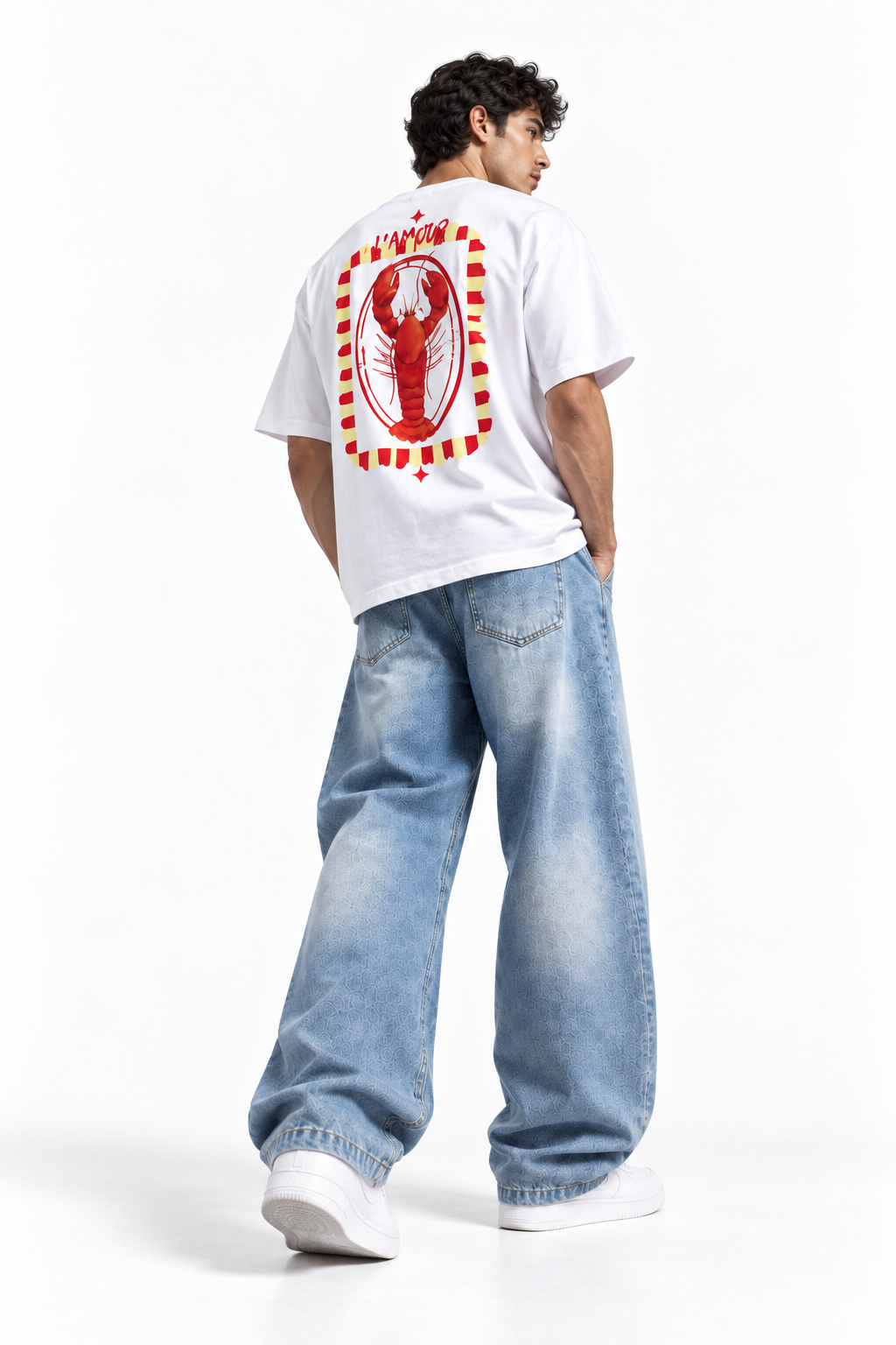 A man wearing a white t-shirt with a large red lobster graphic on the back, paired with wide-leg light blue jeans and white sneakers, shown from behind against a white studio background.