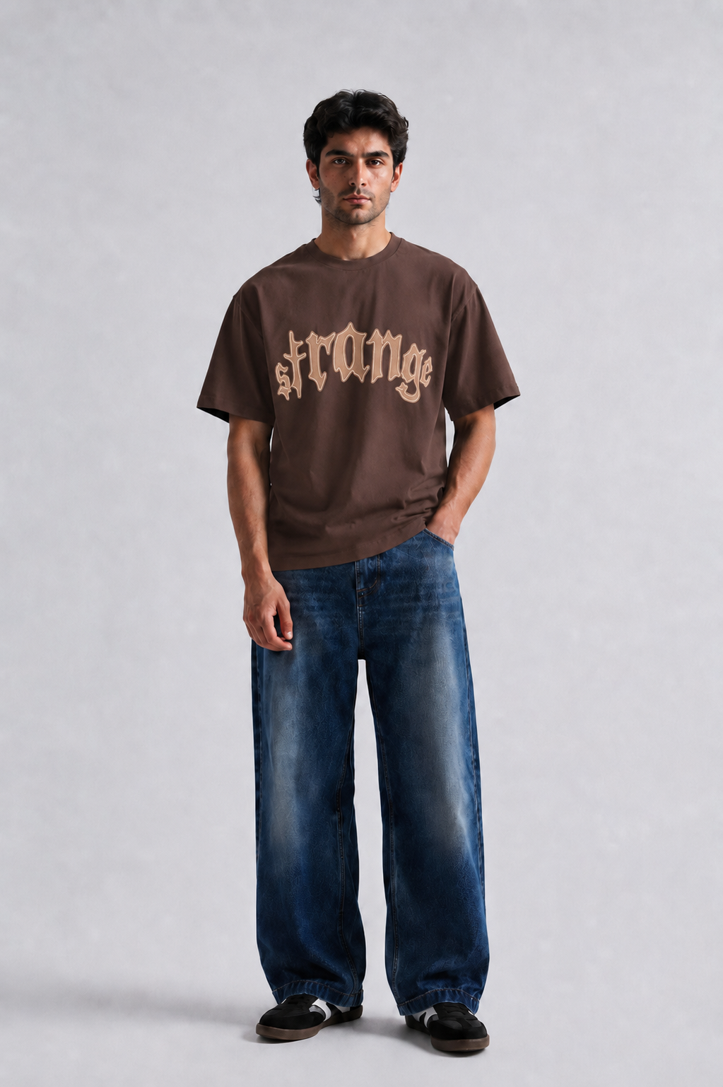 Model wearing brown Strange oversized graphic t-shirt