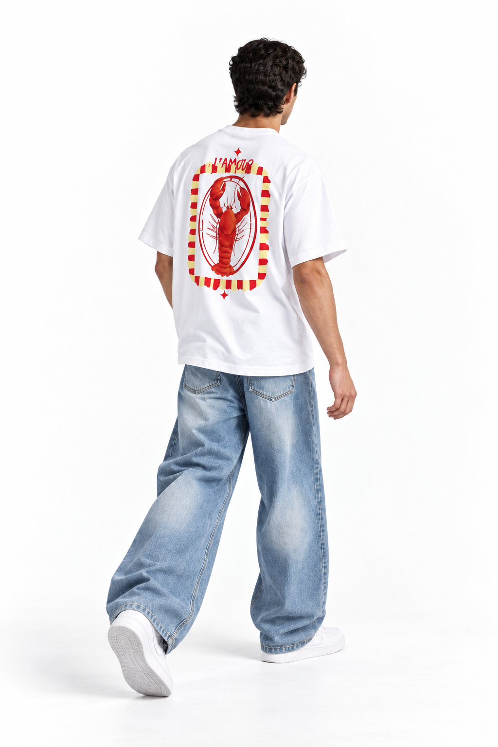 A man shown from behind wearing a white t-shirt with a large red lobster graphic on the back, paired with light blue jeans and white sneakers, against a plain white studio background.