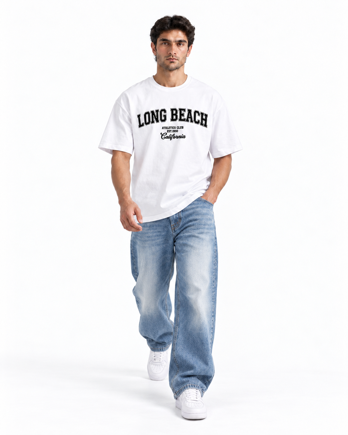 A man modeling a white short-sleeve t-shirt with 'LONG BEACH' printed in black across the chest, paired with light blue jeans and white sneakers, against a plain white studio background.