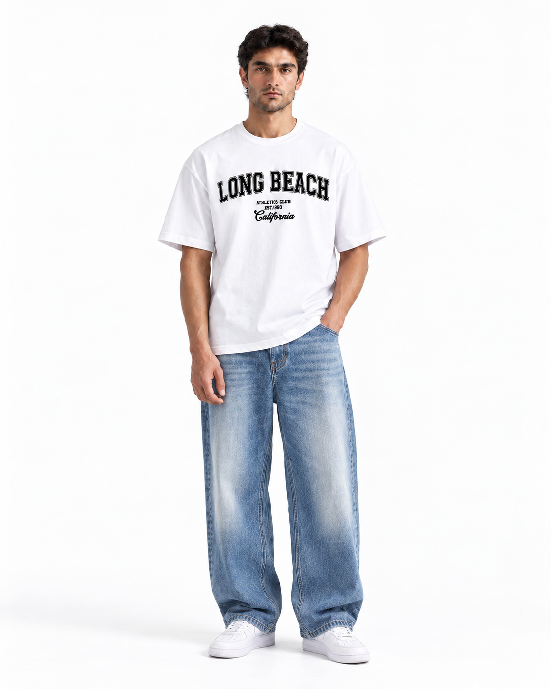 A man modeling a white short-sleeve t-shirt with 'LONG BEACH' printed in black across the chest, paired with wide-leg light blue jeans and white sneakers, against a plain white studio background.