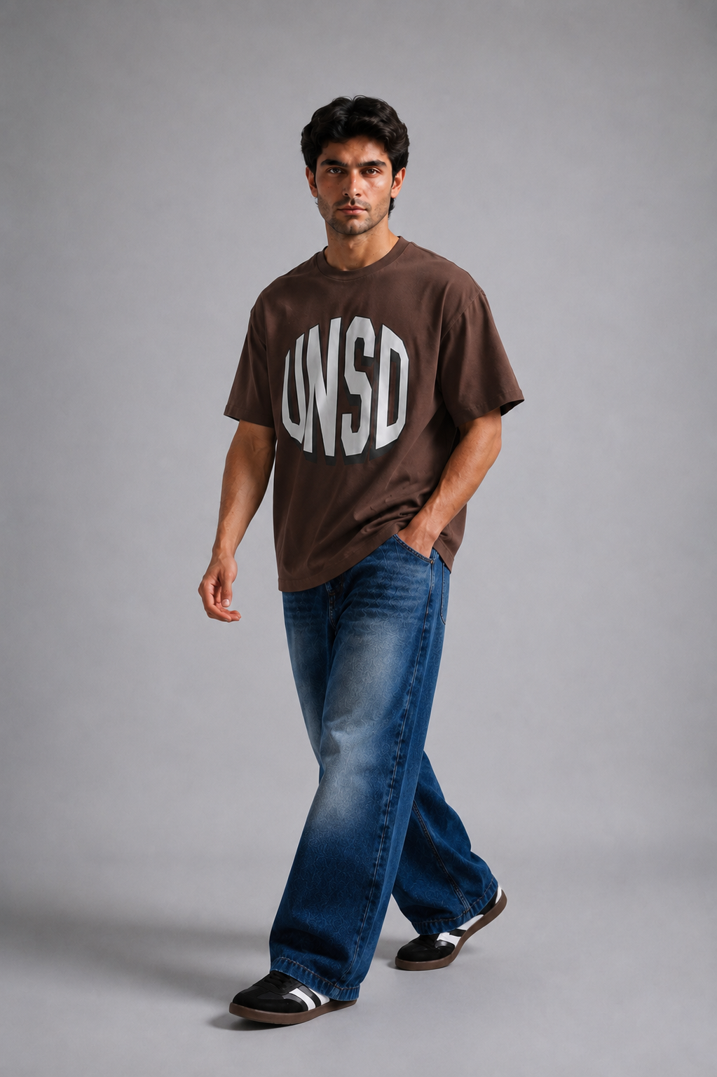 Model wearing brown UNSTD oversized graphic t-shirt