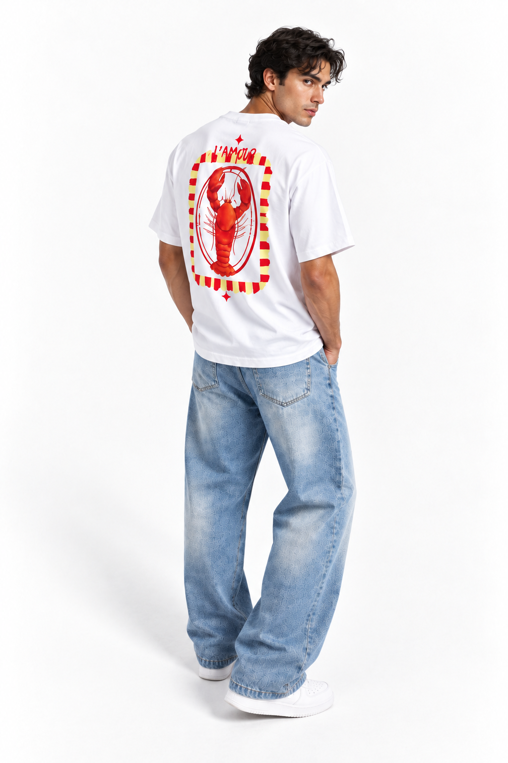 A man wearing a white t-shirt with a large red lobster graphic on the back, paired with light-wash blue jeans and white sneakers, photographed from behind against a white studio background.